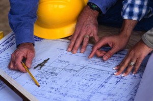 Hands of Couple Looking at Blueprints